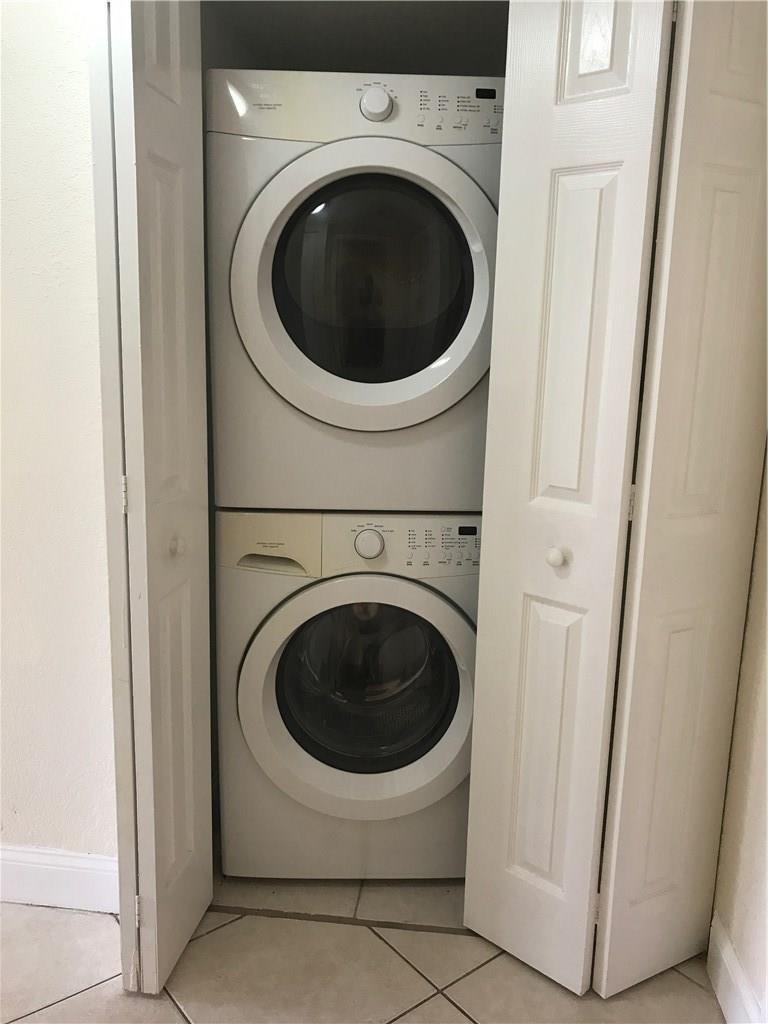 A stacked washer and dryer unit is housed inside a white bi-fold door closet — 1105 S Flagler Avenue # 601, Pompano Beach FL 33060, POMPANO BEACH, FL