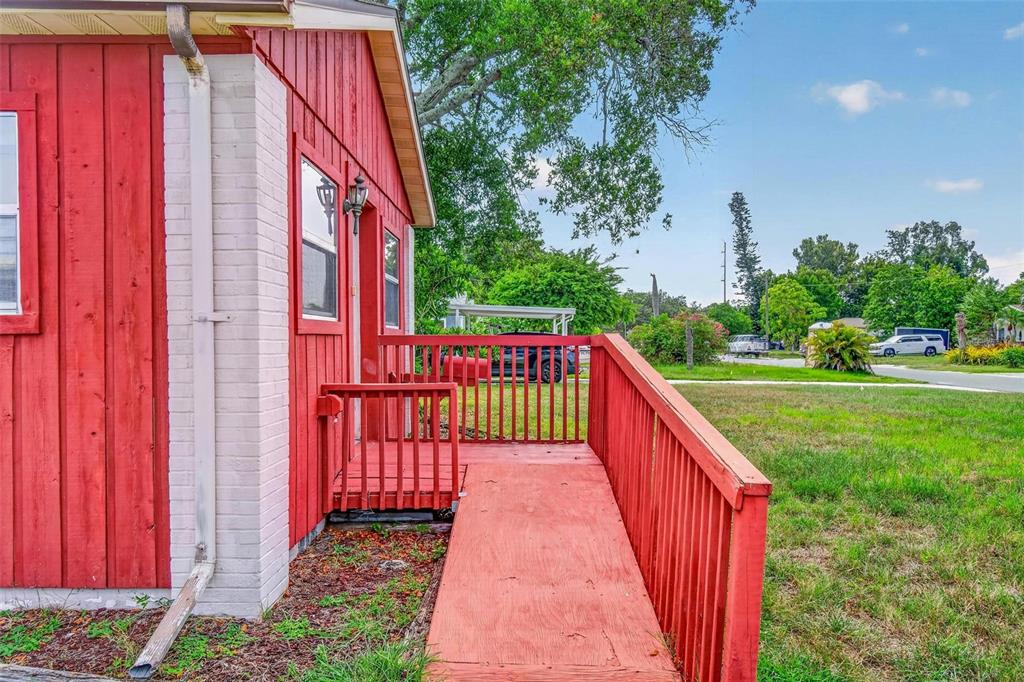 A red wooden building features a wheelchair ramp leading to a small porch — 2600 25TH AVENUE N, ST PETERSBURG, FL