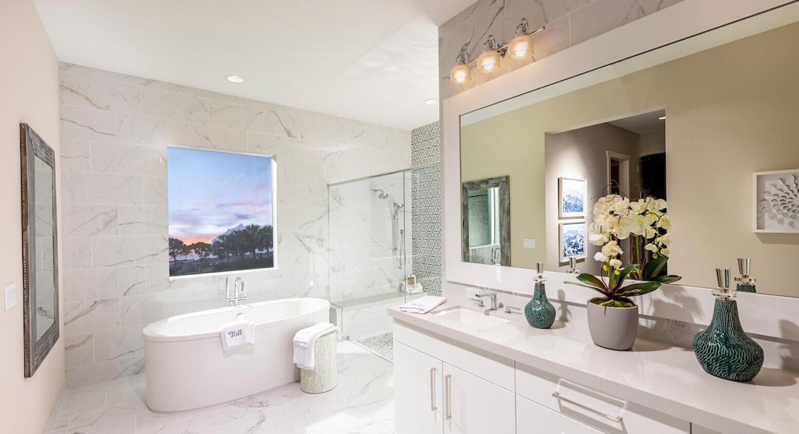 A modern bathroom features a freestanding tub, a glass-enclosed shower, and a white vanity — 9858 Regency Way, Palm Beach Gardens FL 33412, PALM BEACH GARDENS, FL