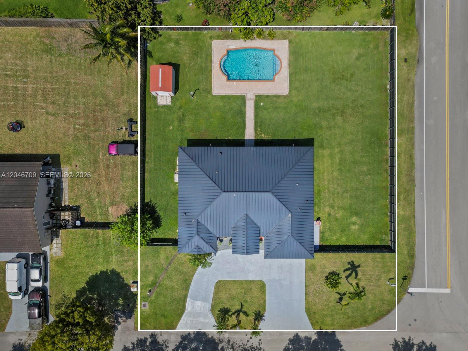 An aerial view shows a house with a metal roof, a pool, and a shed — 13205 SW 218th Ter, Miami FL 33170, MIAMI, FL