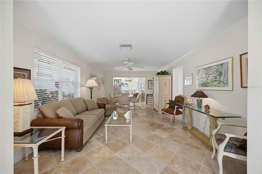 A living room features tile flooring, a beige sofa, and a glass-topped console table — 6005 MIDNIGHT PASS ROAD UNIT N4, SARASOTA, FL