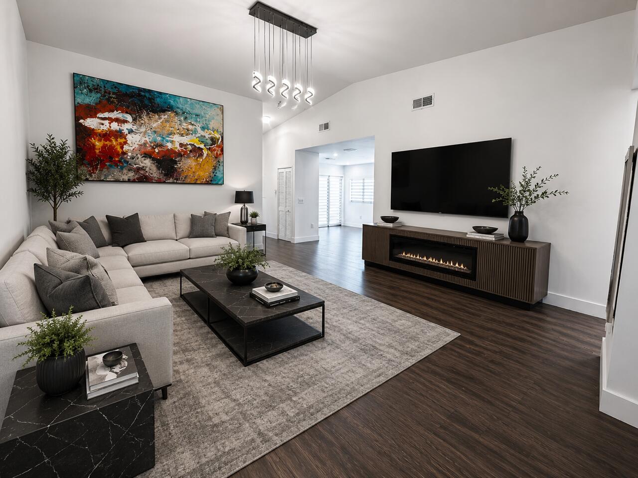 A modern living room features a sectional sofa, a fireplace console, and a large abstract painting — 1541 N 14th Terrace, Hollywood FL 33020, HOLLYWOOD, FL