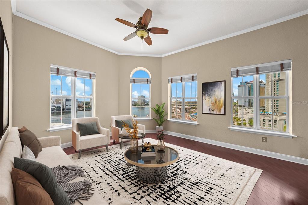 A living room with a ceiling fan, patterned rug, and windows overlooking a city skyline — 700 S HARBOUR ISLAND BOULEVARD UNIT 813, TAMPA, FL