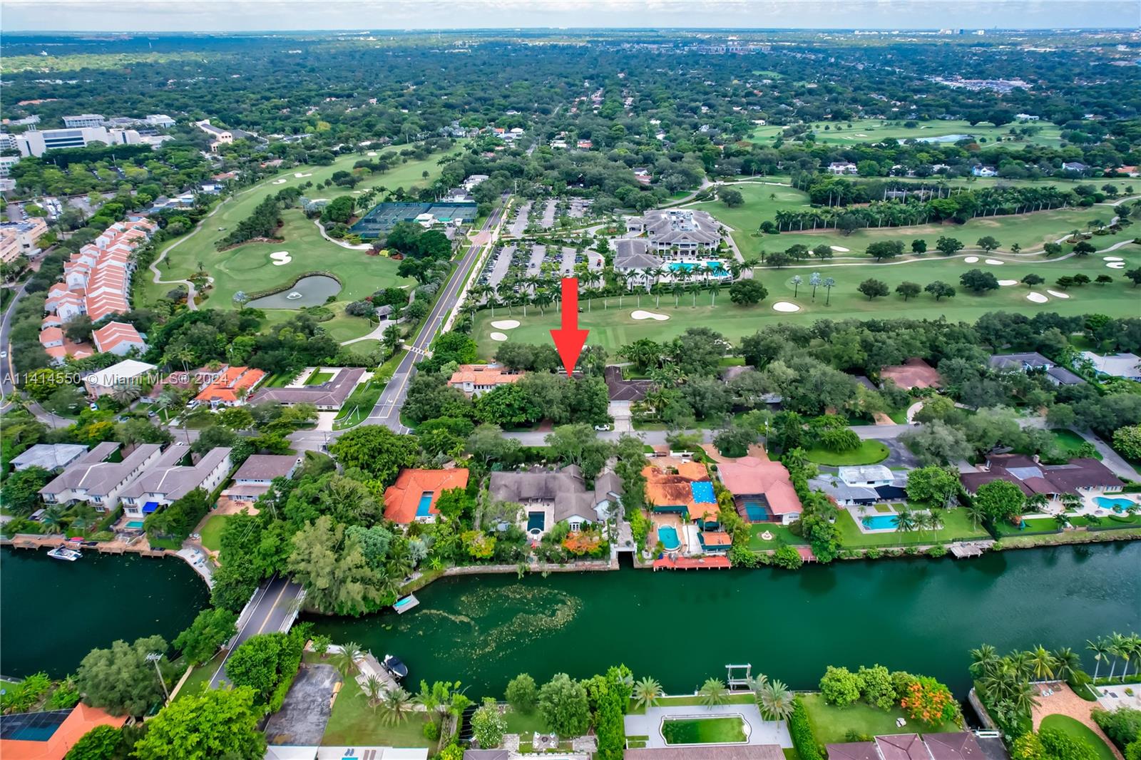 An aerial view shows a residential neighborhood with houses, a canal, and a golf course — 4716 University Dr, Coral Gables FL 33146, CORAL GABLES, FL