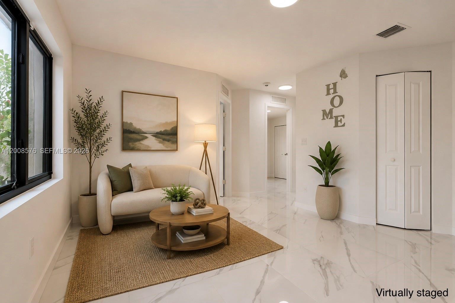 A virtually staged living area features white marble floors, a small sofa, and neutral decor — 152 NW 18 St, Homestead FL 33030, HOMESTEAD, FL