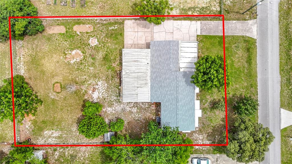 An aerial view shows a house with a gray roof, a driveway, and a large yard — 12331 PARKWOOD STREET, HUDSON, FL