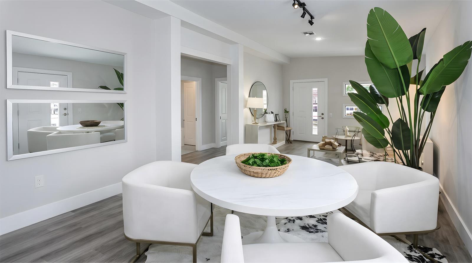 A dining area with a round white table, four chairs, and a large potted plant — 2112 NW 83rd Street, Miami FL 33147, MIAMI, FL