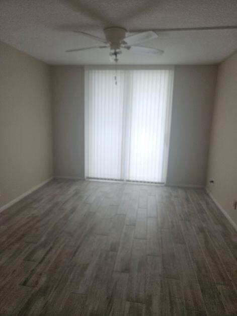An empty room features light-colored wood-look tile flooring and a ceiling fan — 1421 S Ocean Boulevard # 412, Pompano Beach FL 33062, POMPANO BEACH, FL