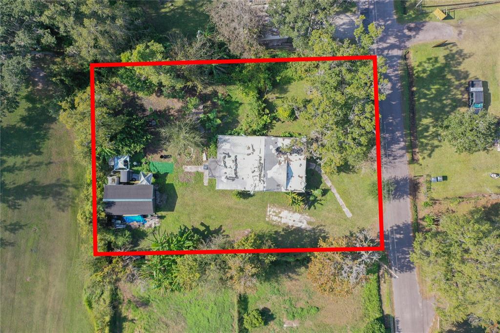 An aerial view shows a house and a detached structure within a red-bordered lot — 3346 STRICKLAND ROAD, LAKELAND, FL