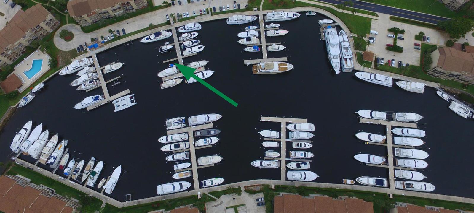 An aerial view shows a marina filled with numerous docked boats and yachts — 1320 Tidal Pointe Boulevard, Jupiter FL 33477, JUPITER, FL