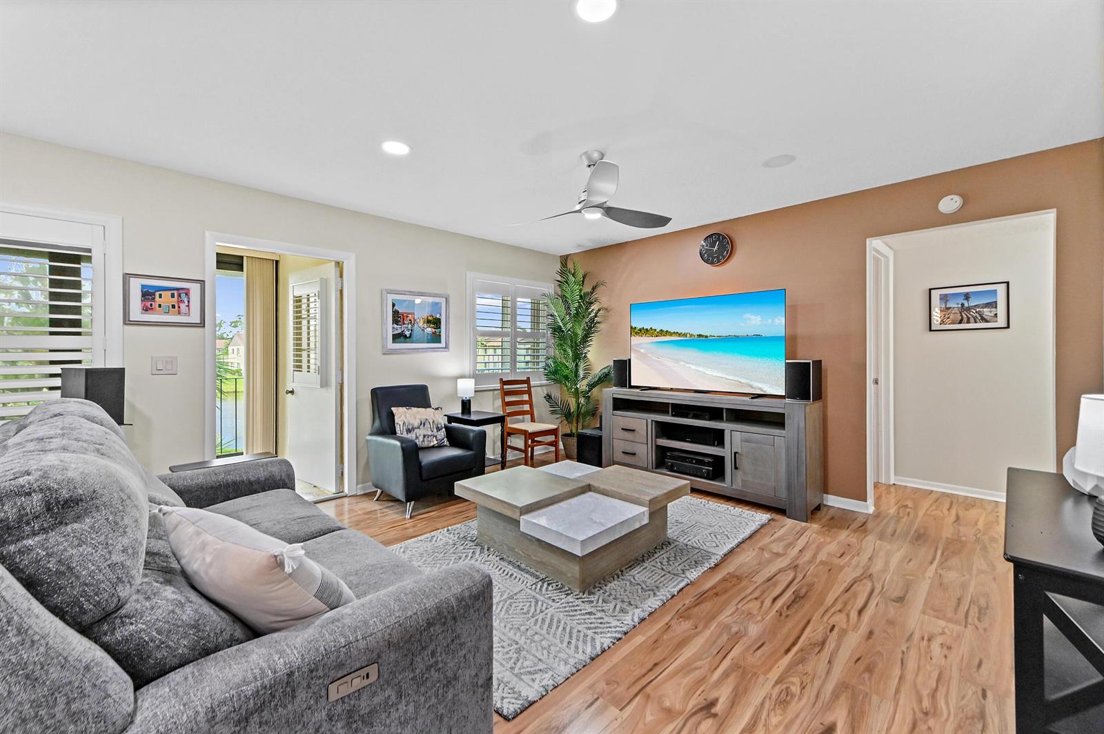 A living room features a gray sofa, a wooden coffee table, and a television console — 3561 Pine Tree Court # 2, FL 33463, FL