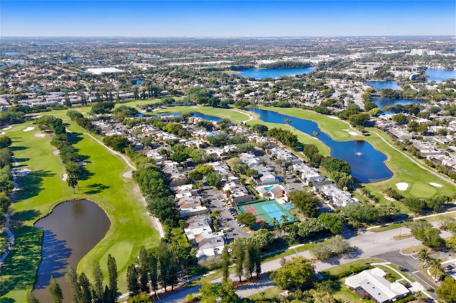 An aerial view of a residential community featuring townhomes, a tennis court, and golf course — 1391 E Golfview Drive # 1391, Pembroke Pines FL 33026, PEMBROKE PINES, FL