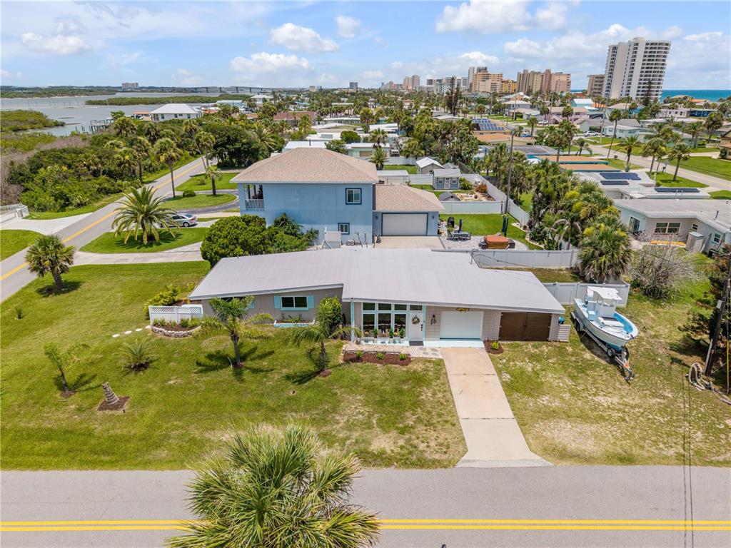 An aerial view shows a single-story house with a boat parked in the side yard — 3929 S PENINSULA DRIVE, PORT ORANGE, FL