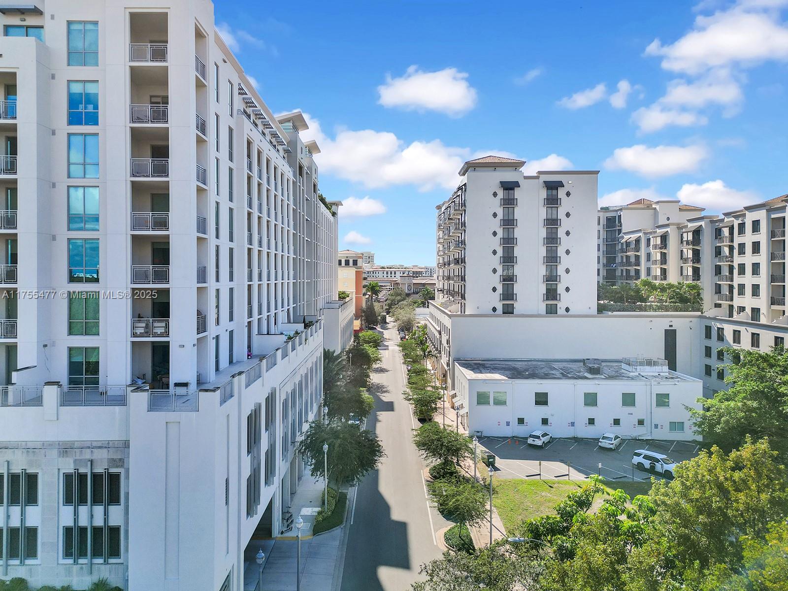 An elevated view shows a street between two large white apartment buildings with balconies — 4070 Laguna St, Coral Gables FL 33146, CORAL GABLES, FL