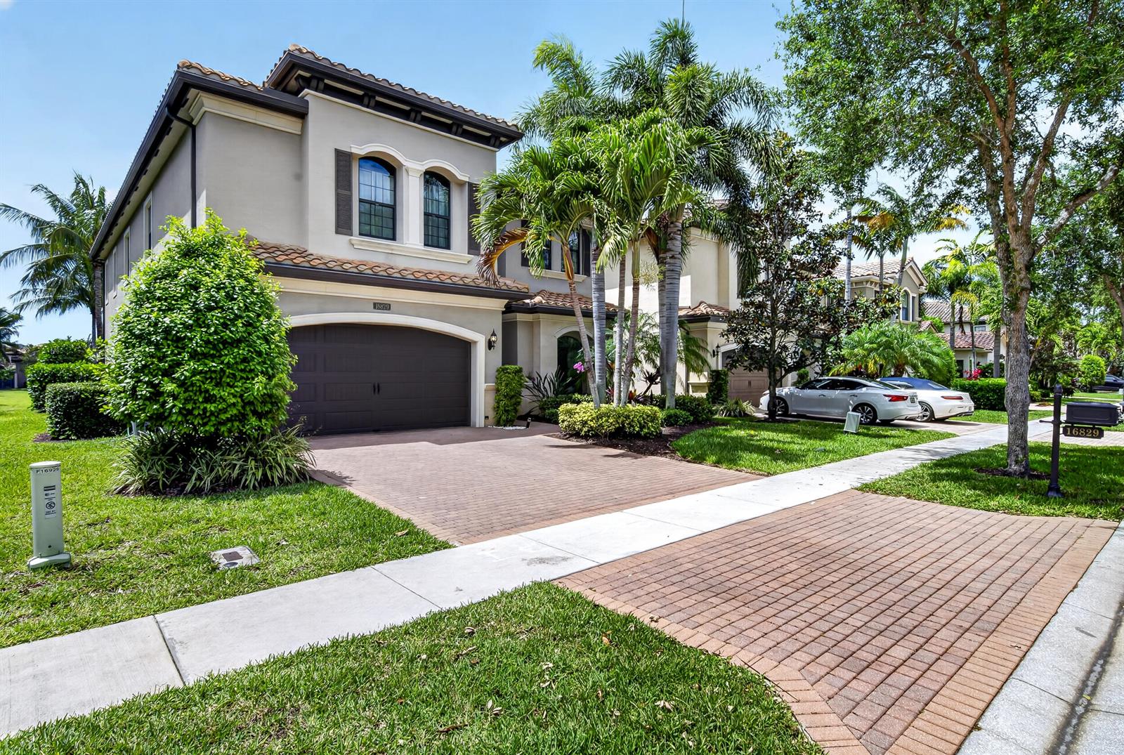 A two-story stucco house with a brick driveway, palm trees, and a two-car garage — 16829 Newark Bay Road, Delray Beach FL 33446, DELRAY BEACH, FL