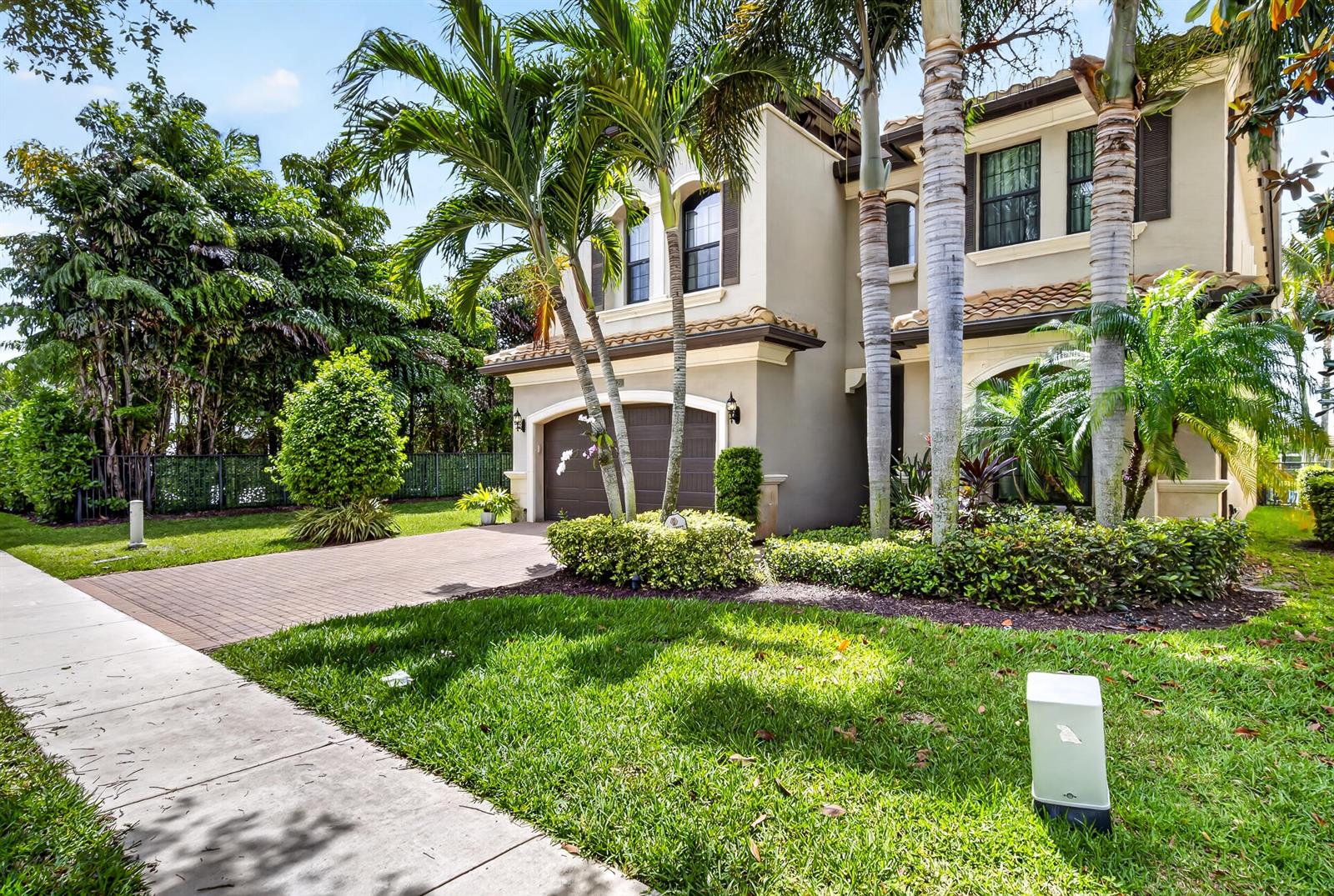 A two-story suburban house with a paved driveway, palm trees, and a manicured front lawn — 16829 Newark Bay Road, Delray Beach FL 33446, DELRAY BEACH, FL