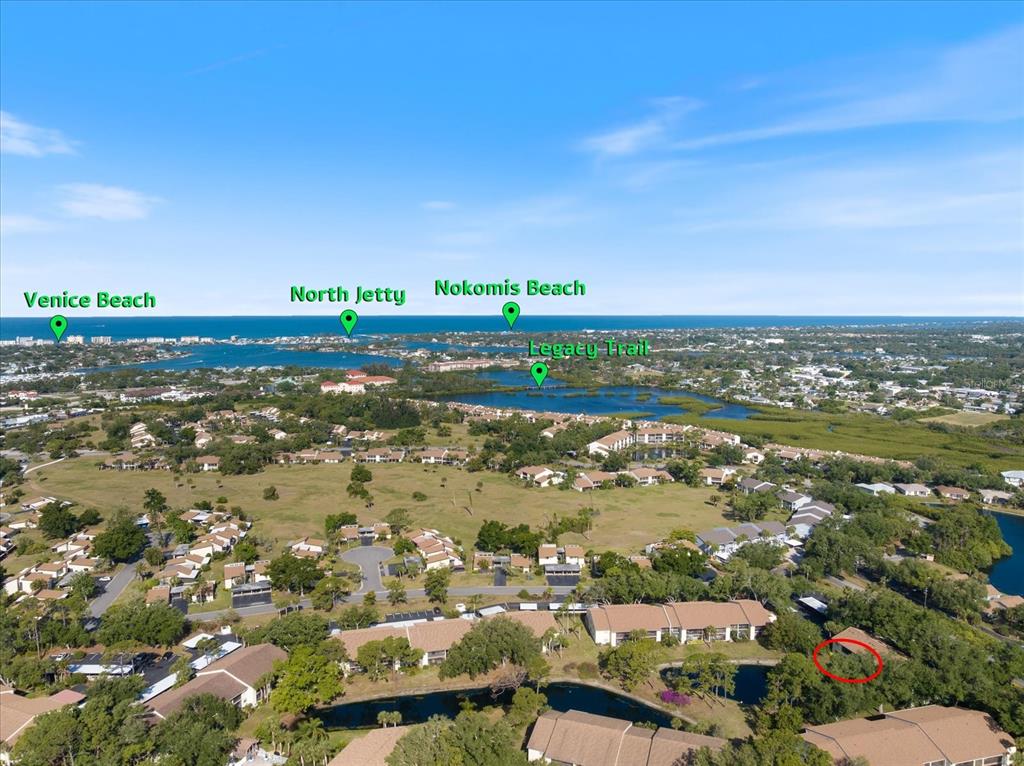 This is an aerial view of a residential neighborhood with labeled landmarks and a red circle — 772 BIRD BAY DRIVE N UNIT 104, VENICE, FL