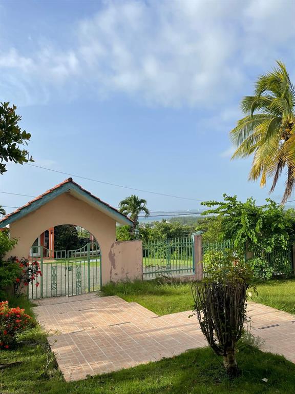 A gated entrance with a tiled driveway leads to a house with a view — PR-115 KM 19.8 INT, AGUADA, PR