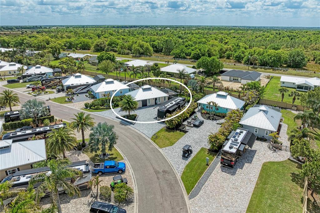 An aerial view shows a house with a large paved driveway and a parked RV — 8602 SW SAND CRANE CIRCLE LOT 51, ARCADIA, FL