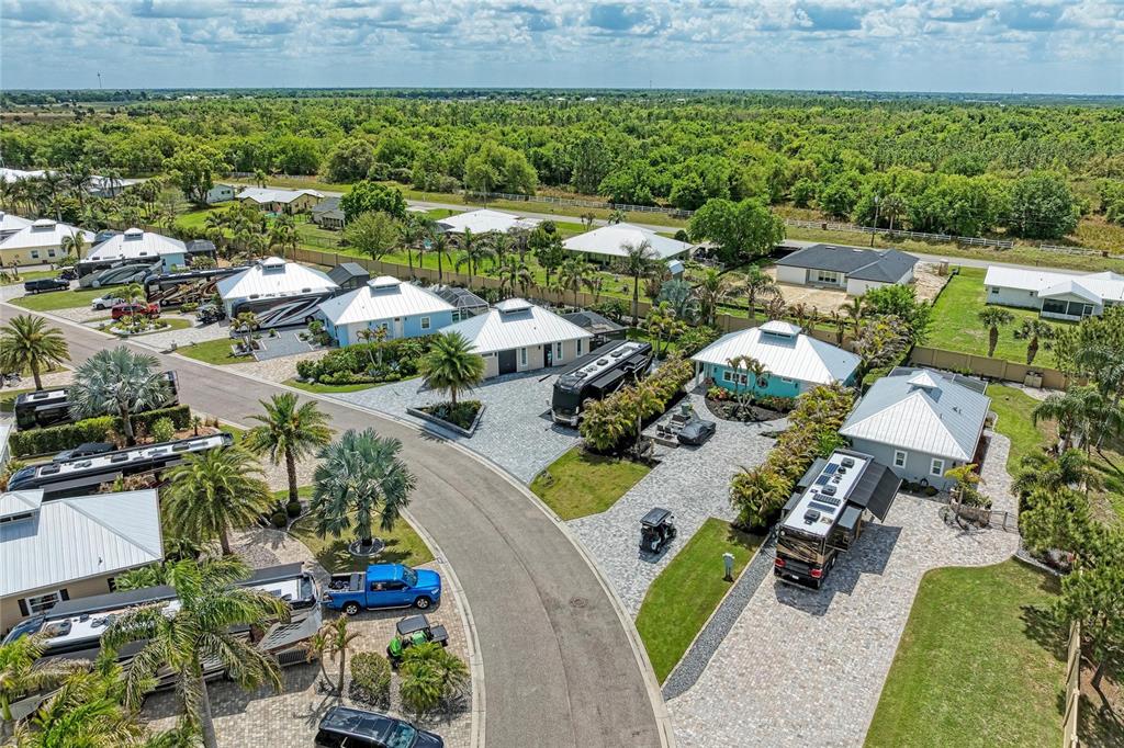An aerial view shows several houses with attached RV garages and parked motorhomes — 8602 SW SAND CRANE CIRCLE LOT 51, ARCADIA, FL