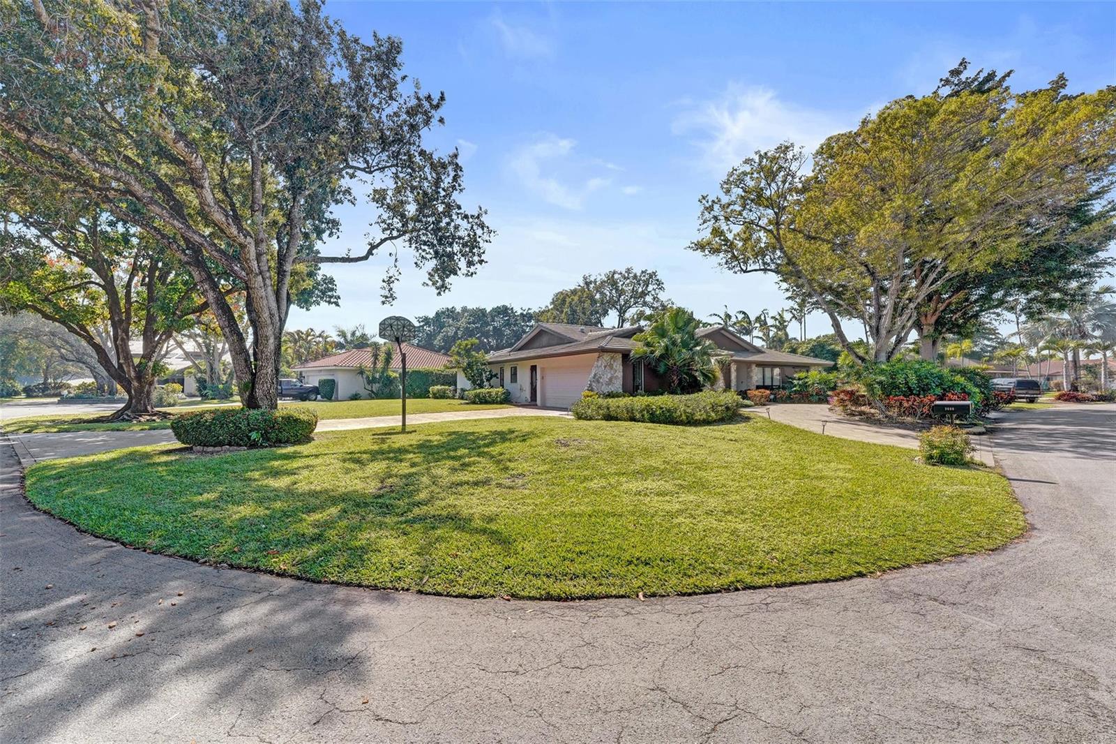 A single-story house with a garage and a large front lawn under mature trees — 9600 Conch Shell Manor, Plantation FL 33324, PLANTATION, FL