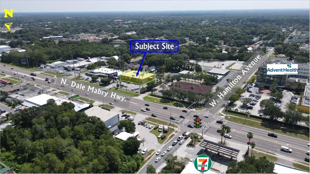 This aerial view shows a commercial building highlighted at a busy intersection near a hospital — 7211 N DALE MABRY HIGHWAY N, TAMPA, FL