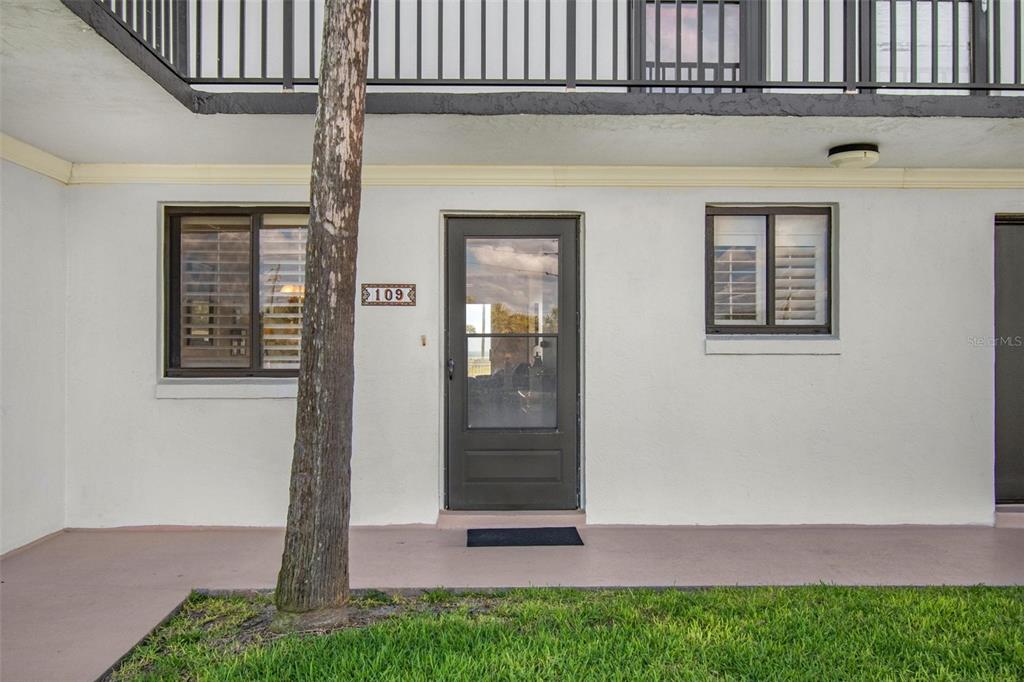 The exterior of a ground-floor apartment unit features a front door numbered 109 — 3500 S OCEAN SHORE BOULEVARD UNIT 109, FLAGLER BEACH, FL