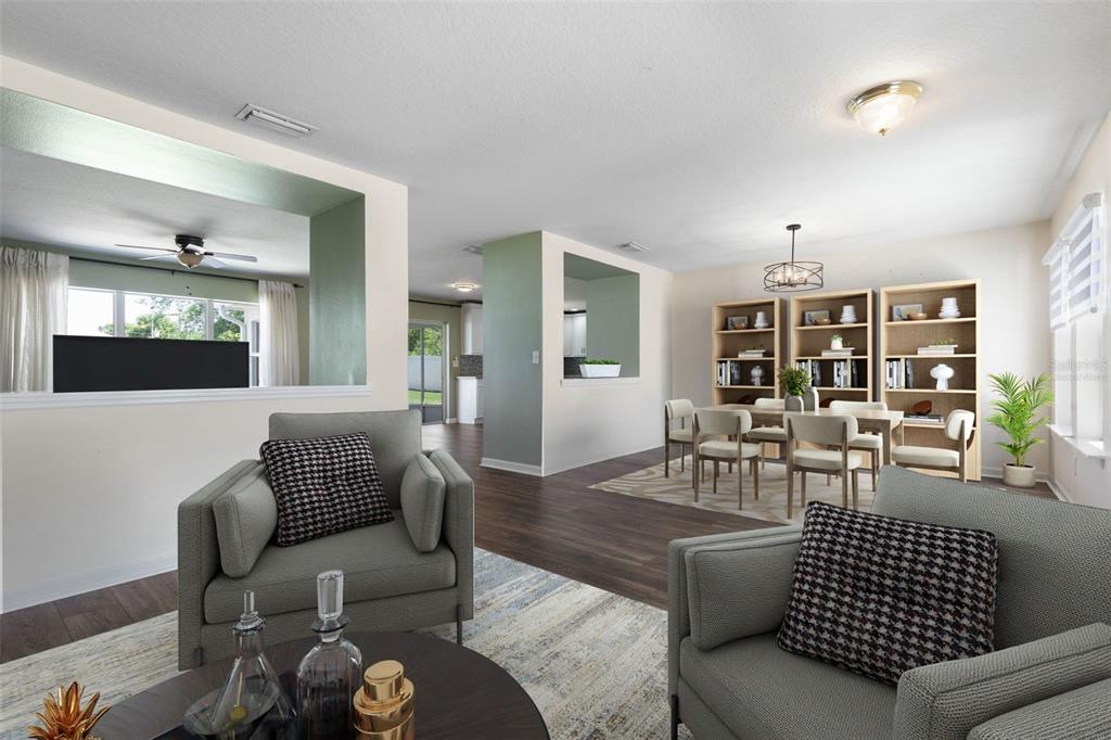 A living room and dining area with gray armchairs, wood flooring, and built-in shelving — 27 WOOD ARBOR LANE, PALM COAST, FL