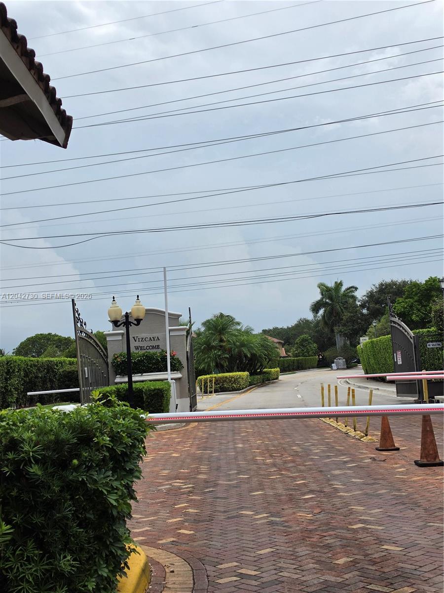 A gated entrance with a brick driveway leads to a sign welcoming visitors to Vizcaya — 4906 SW 141st Ave # 4, Miramar FL 33027, MIRAMAR, FL