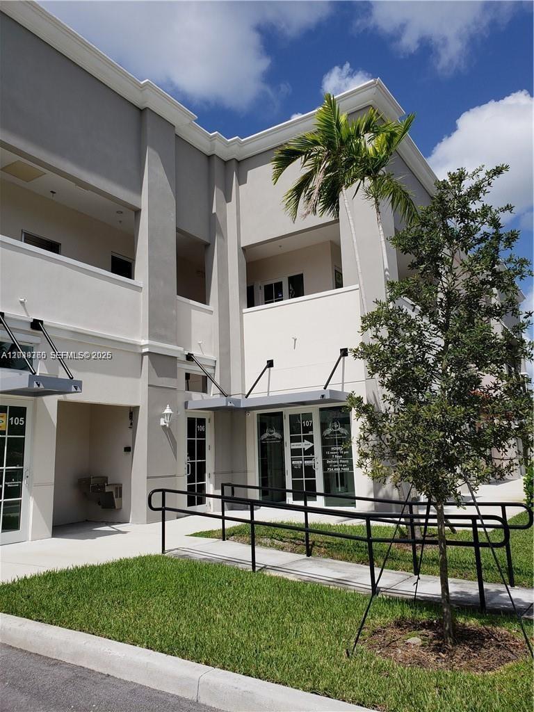 A two-story commercial building exterior features glass storefronts numbered 105, 106, and 107 — 2101 SW 101st Ave # 203, Miramar FL 33025, MIRAMAR, FL