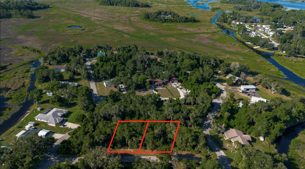 An aerial view shows two adjacent wooded lots outlined in red within a residential area — 4374 E MATE LANE, HERNANDO, FL