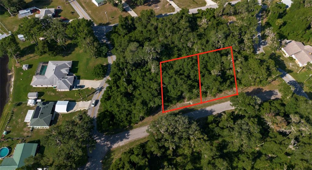 An aerial view shows two adjacent, wooded rectangular lots outlined in red near a road — 4374 E MATE LANE, HERNANDO, FL