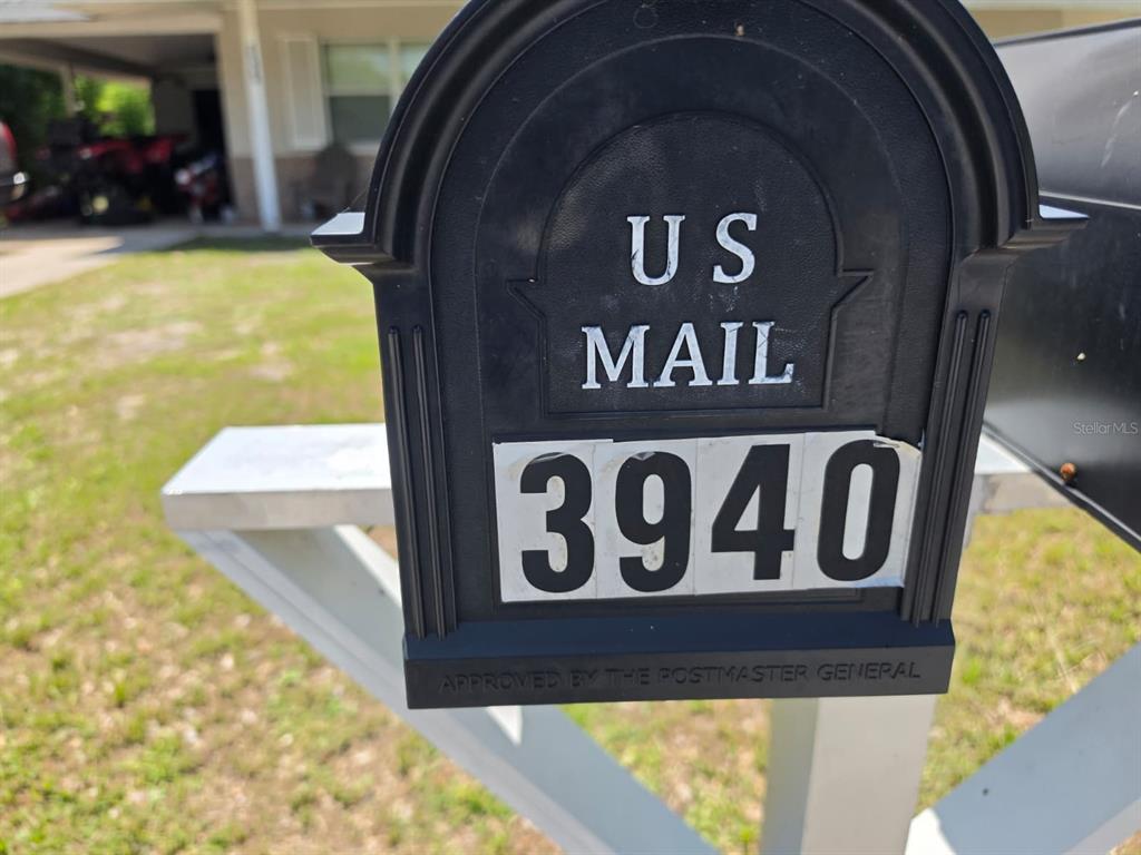 A black mailbox with the number 3940 stands on a post in a residential yard — 3940 BERKSHIRE DRIVE, SARASOTA, FL