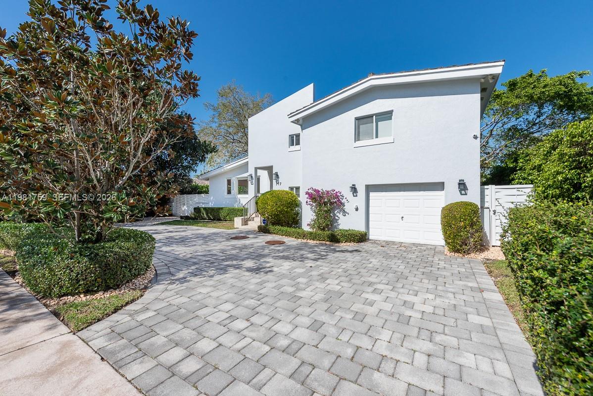 A two-story white house with a paved driveway and a single-car garage — 717 Benevento Ave, Coral Gables FL 33146, CORAL GABLES, FL