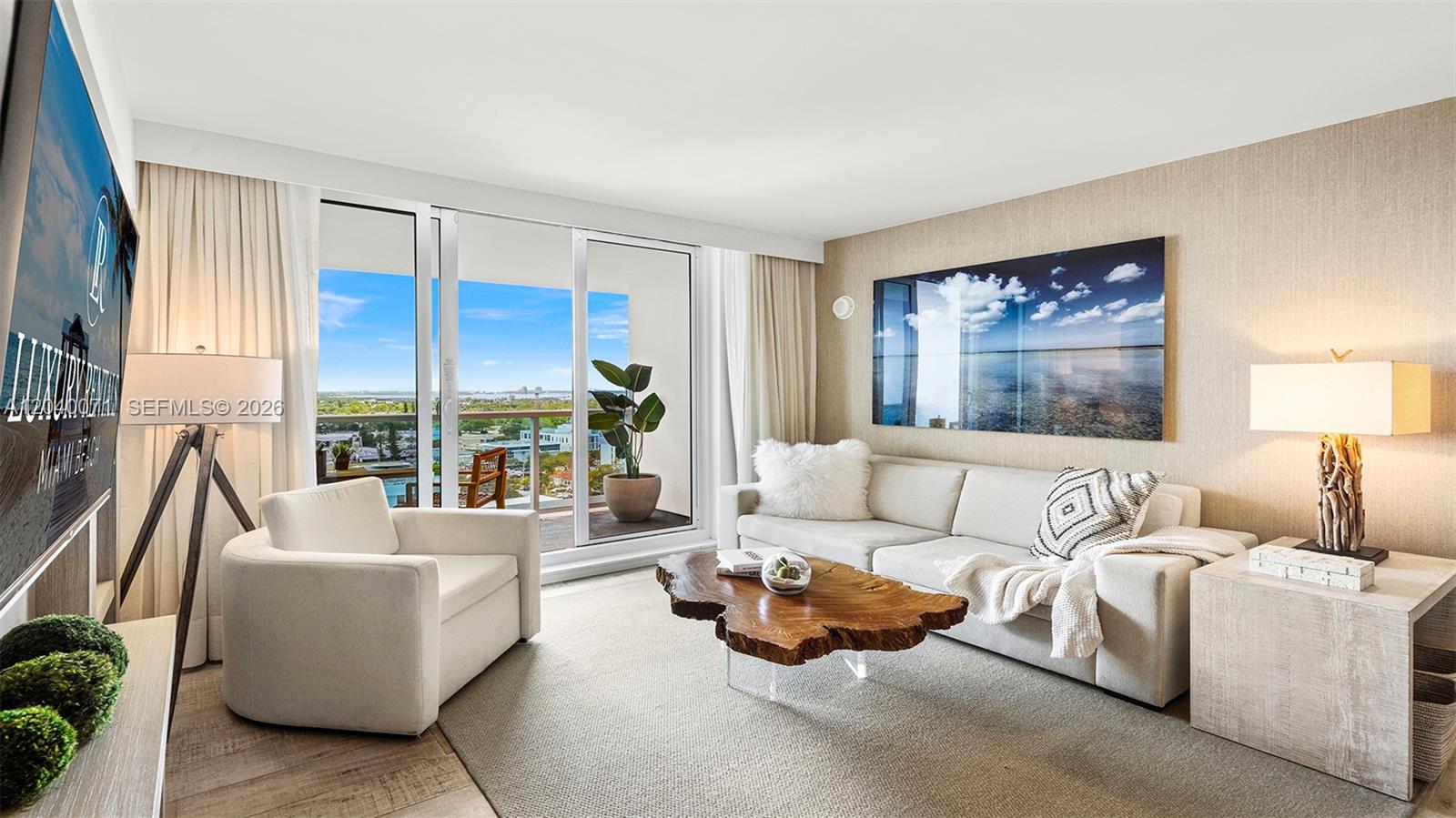 A modern living room features a live-edge coffee table, a white sofa, and a balcony — 102 24 # 1545, Miami Beach FL 33139, MIAMI BEACH, FL