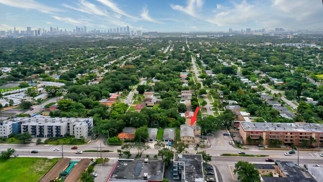 An aerial view shows a residential neighborhood with a red arrow pointing to a building — 14305 NE 6th Ave, North Miami FL 33161, NORTH MIAMI, FL