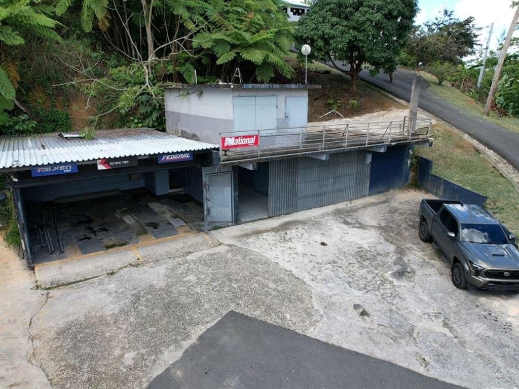 An elevated view of a commercial building with a garage bay and a paved lot — Carr 568 Km 30.3 Int CARR 568 KM 30.3 INT, COROZAL, PR 00783, COROZAL, PR