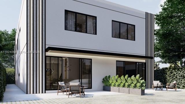 This is a rendering of the exterior of a modern two-story house with a patio — 610 NW 25th Ct, Miami FL 33125, MIAMI, FL