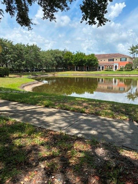 A pond sits in front of a multi-story residential building surrounded by trees — 2551 SW 99th Way, Miramar FL 33025, MIRAMAR, FL
