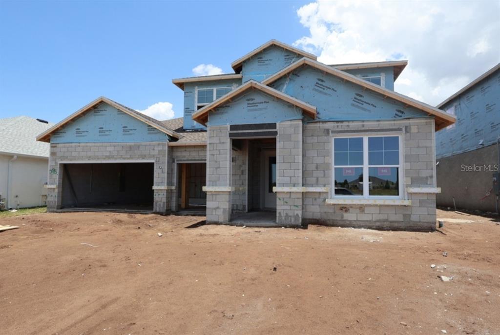 A two-story house under construction with concrete block walls and blue weather-resistant sheathing — 7713 MARINA BAY COVE, PALMETTO, FL