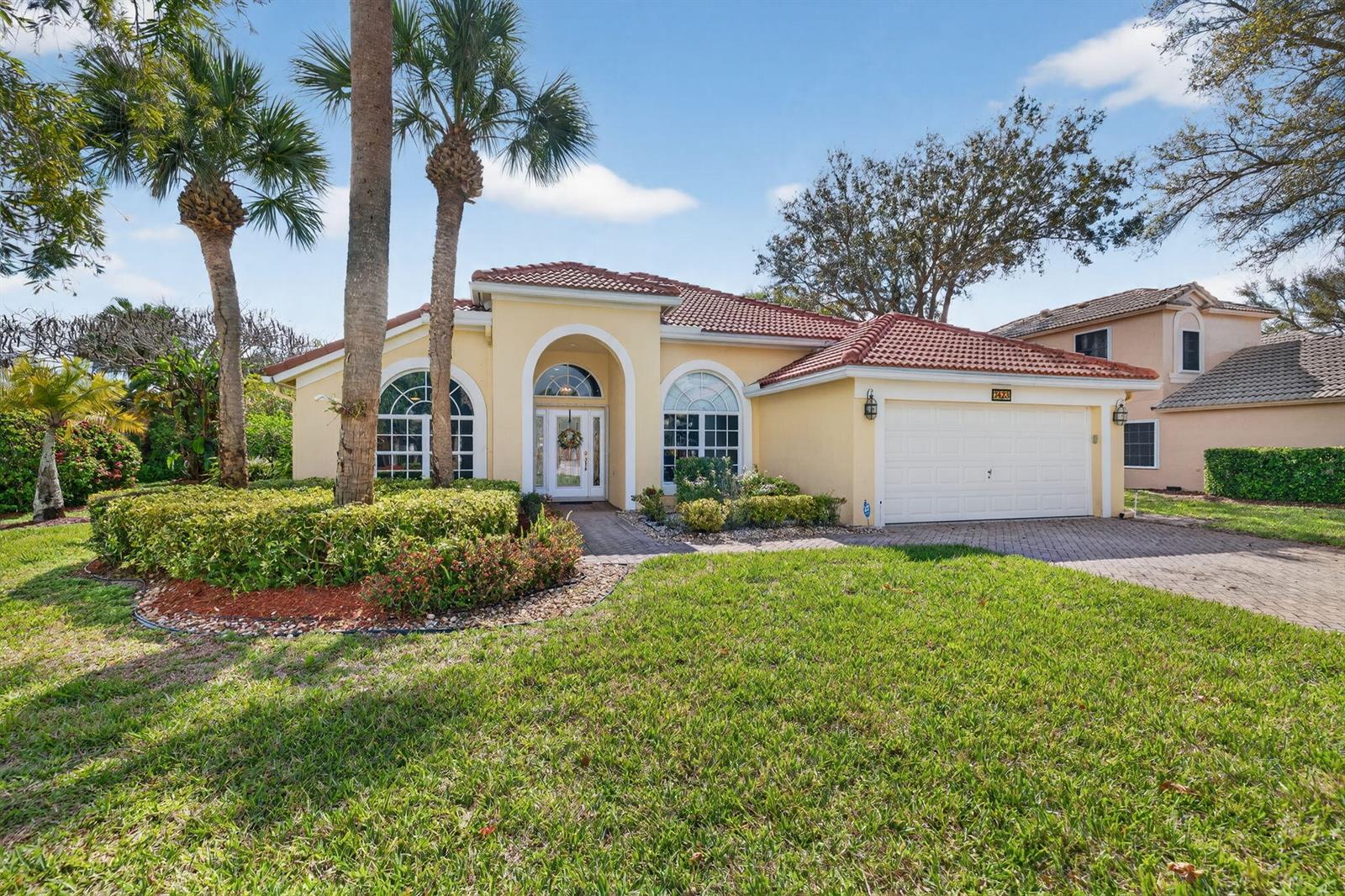 A single-story yellow stucco house with a red tile roof and a two-car garage — 7423 Brunswick Circle, Boynton Beach FL 33472, BOYNTON BEACH, FL