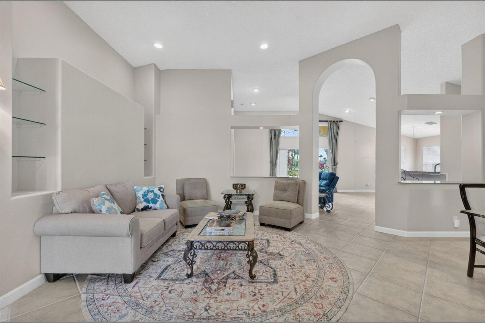 A living room features a beige sofa, two armchairs, a coffee table, and tile flooring — 7423 Brunswick Circle, Boynton Beach FL 33472, BOYNTON BEACH, FL