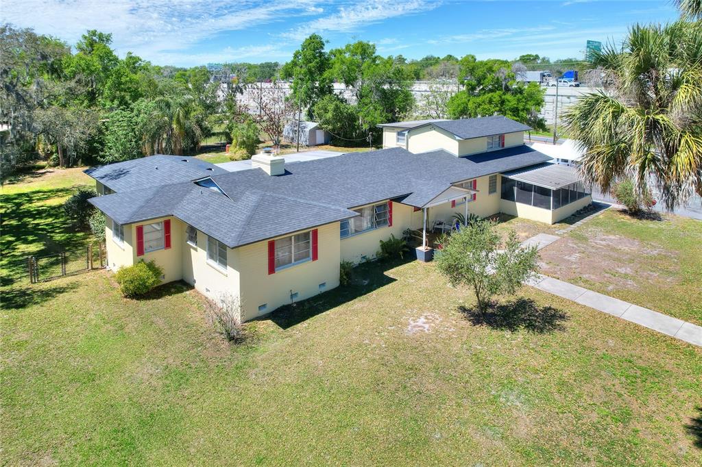 An aerial view of a yellow, single-story house with a dark shingled roof and shutters — 750 CHARLIE TAYLOR ROAD, PLANT CITY, FL
