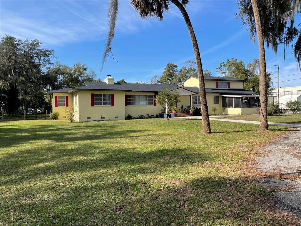 A yellow single-story house with red shutters sits on a large, grassy lot — 750 CHARLIE TAYLOR ROAD, PLANT CITY, FL