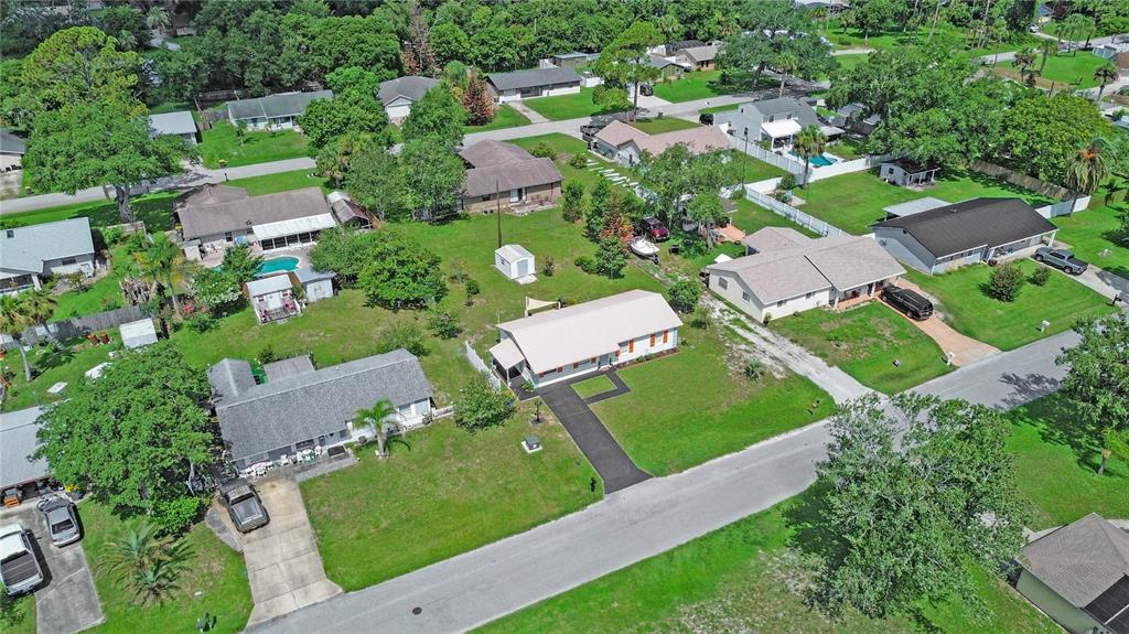An aerial view shows several single-story residential houses with driveways and lawns in a neighborhood — 2820 SABAL PALM DRIVE, EDGEWATER, FL