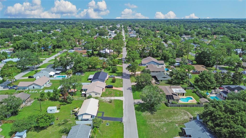 An aerial view of a suburban street lined with houses, trees, and swimming pools — 2820 SABAL PALM DRIVE, EDGEWATER, FL