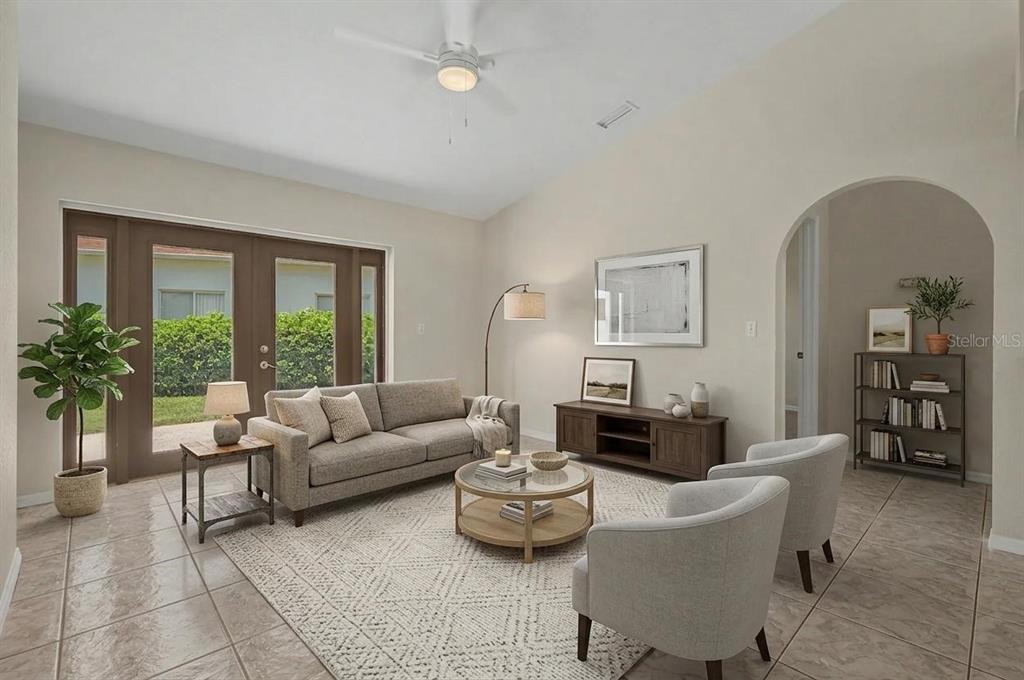 A living room features a sofa, two armchairs, a coffee table, and tile flooring — 6208 HUNTINGTON DRIVE, ZEPHYRHILLS, FL