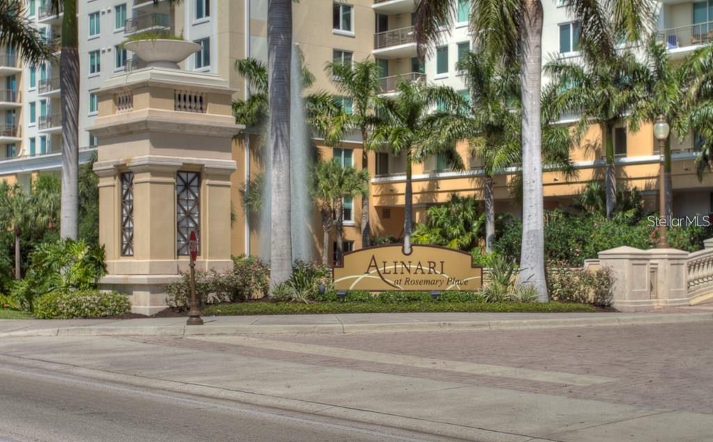 The exterior entrance of the Alinari at Rosemary Place condominium complex features a fountain and signage — 800 N TAMIAMI TRAIL UNIT 905, SARASOTA, FL