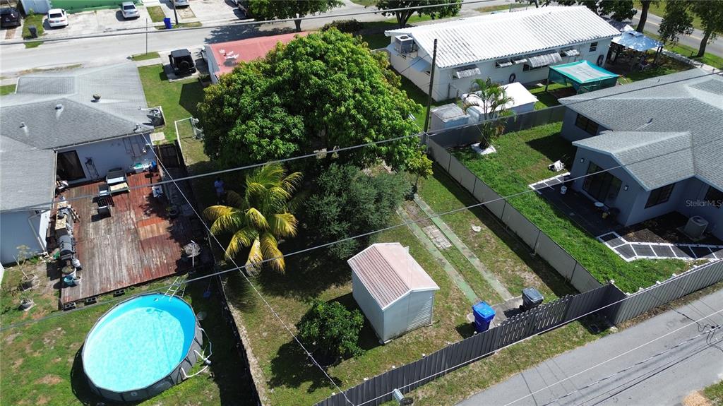An aerial view shows a backyard with a pool, a shed, and a large tree — 2447 ARTHUR STREET, HOLLYWOOD, FL