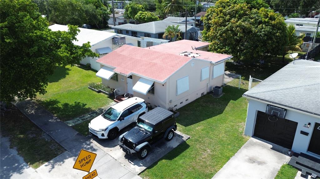 An aerial view shows a single-story house with a red roof and two parked cars — 2447 ARTHUR STREET, HOLLYWOOD, FL